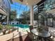 Enclosed pool area featuring a spiral staircase, seating, plants, and views of the lake at 254 Sylvan Blvd, Winter Park, FL 32789