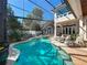 Enclosed pool and spa area with poolside seating and spiral staircase leading to the upper level at 254 Sylvan Blvd, Winter Park, FL 32789