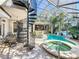 Enclosed pool area features a swim-up bar, hot tub, lounging areas, and spiral staircase to upper level at 254 Sylvan Blvd, Winter Park, FL 32789
