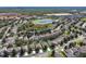 Aerial view of homes in a residential community with lush greenery and a scenic pond nearby at 2683 Manesty Ln, Kissimmee, FL 34747