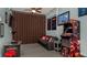 Finished basement with multiple video game stations, comfortable seating, and decorative wall hangings at 2683 Manesty Ln, Kissimmee, FL 34747
