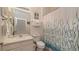 Well-lit bathroom featuring a shower and tub, a single sink, and sea-themed decorations at 2683 Manesty Ln, Kissimmee, FL 34747