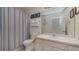 Nautical themed bathroom featuring a shower with blue striped curtain, toilet, and vanity with sink at 2683 Manesty Ln, Kissimmee, FL 34747