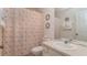 Nautical themed bathroom featuring a shower with patterned curtain, toilet, and vanity with sink and mirror at 2683 Manesty Ln, Kissimmee, FL 34747
