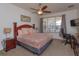Comfortable bedroom featuring a plush bed, ceiling fan, and a view of the outdoor patio at 2683 Manesty Ln, Kissimmee, FL 34747