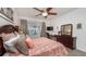 Comfortable bedroom features a wooden dresser, a work space and a large bed with sea-themed linens overlooking the pool at 2683 Manesty Ln, Kissimmee, FL 34747