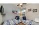 Nautical themed bedroom with two twin beds, a ceiling fan, and a painting of the beach at 2683 Manesty Ln, Kissimmee, FL 34747
