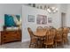 Warm and inviting dining area featuring a wood table with seating for six and stylish decor at 2683 Manesty Ln, Kissimmee, FL 34747