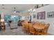 Well-lit dining area open to the living room, featuring a wooden table and seating for six at 2683 Manesty Ln, Kissimmee, FL 34747