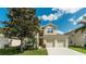 Charming two-story home featuring a well-manicured lawn and a spacious two-car garage at 2683 Manesty Ln, Kissimmee, FL 34747