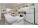 Bright kitchen with white cabinetry, modern appliances, and a cozy breakfast bar with seating at 2683 Manesty Ln, Kissimmee, FL 34747