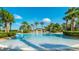 A large, inviting swimming pool surrounded by palm trees and lush landscaping offers a serene and luxurious community space at 2683 Manesty Ln, Kissimmee, FL 34747