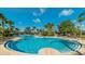 Large luxurious community pool surrounded by tropical landscaping and sun loungers creates a perfect place for relaxation and recreation at 2683 Manesty Ln, Kissimmee, FL 34747