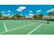 Well-maintained community tennis courts with lush green surroundings under a bright blue sky with puffy clouds at 2683 Manesty Ln, Kissimmee, FL 34747