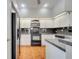 Kitchen with black appliances, white cabinets, and a breakfast bar at 3084 Stillwater Dr, Kissimmee, FL 34743