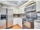 The kitchen features granite countertops, white cabinets, and stainless steel appliances at 3084 Stillwater Dr, Kissimmee, FL 34743