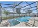 Backyard featuring a pool and jacuzzi under a screened enclosure and a grass yard at 3084 Stillwater Dr, Kissimmee, FL 34743