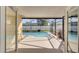 View of a covered patio leading to a refreshing pool with a screened enclosure at 3084 Stillwater Dr, Kissimmee, FL 34743