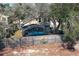 Backyard features a screened-in patio with hot tub surrounded by mature trees at 3623 S Saint Lucie Dr, Casselberry, FL 32707