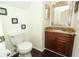Bathroom with wood cabinets, granite countertops, and a commode at 3623 S Saint Lucie Dr, Casselberry, FL 32707