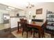 Cozy dining area with wood table, chairs, and a view to the adjacent kitchen at 3623 S Saint Lucie Dr, Casselberry, FL 32707