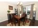 Dining room with dark wood floors, a large table, and stylish decor, perfect for Gathering gatherings at 3623 S Saint Lucie Dr, Casselberry, FL 32707