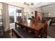 Well-lit dining area with dark wood floors, a spacious table, and large windows providing natural light at 3623 S Saint Lucie Dr, Casselberry, FL 32707