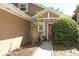 Inviting front entrance with a red door, complemented by attractive landscaping at 3623 S Saint Lucie Dr, Casselberry, FL 32707