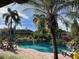 The backyard has an inviting pool with palm trees and lush tropical foliage at 5220 Jade Cir, Orlando, FL 32812