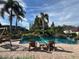 A luxurious pool area with tropical landscaping and lounge chairs for relaxation at 5220 Jade Cir, Orlando, FL 32812