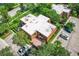 A top-down view of a well-maintained home surrounded by mature trees and ample parking space at 5401 Elm Ct # 303, Orlando, FL 32811