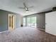 Bright main bedroom with sliding glass doors to a balcony, and connected to the bathroom and closet at 5401 Elm Ct # 303, Orlando, FL 32811