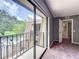 Bedroom with sliding glass doors to balcony and neutral colored carpet at 5401 Elm Ct # 303, Orlando, FL 32811