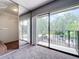 Bedroom with sliding glass doors to balcony, large mirrored closet and neutral colored carpet at 5401 Elm Ct # 303, Orlando, FL 32811