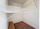 Walk-in closet with built-in shelving and a wooden bench seat with neutral carpet at 5401 Elm Ct # 303, Orlando, FL 32811