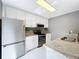 A view of an updated kitchen featuring stainless steel appliances and granite counters at 5401 Elm Ct # 303, Orlando, FL 32811
