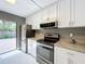 A updated kitchen boasts stainless steel appliances and modern cabinetry at 5401 Elm Ct # 303, Orlando, FL 32811