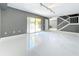 Bright living room with white tile flooring, gray walls, and a sliding glass door to the backyard at 5401 Elm Ct # 303, Orlando, FL 32811