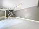 Spacious living room with white tile floors and staircase, offering an open and airy feel at 5401 Elm Ct # 303, Orlando, FL 32811