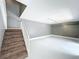 Interior shot of the home, from the stairwell with grey walls and tiled floors at 5401 Elm Ct # 303, Orlando, FL 32811