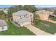 Two-story home with a neutral color palette, well-manicured lawn, and a long driveway at 548 Big Sioux Ct, Kissimmee, FL 34759
