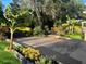 Inviting backyard featuring lush greenery, gravel pathways, and raised garden beds with colorful flowers at 548 Big Sioux Ct, Kissimmee, FL 34759