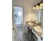 Bathroom featuring a double sink vanity with decorative tile flooring and a shower/tub combo at 548 Big Sioux Ct, Kissimmee, FL 34759