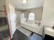 Bright bathroom with a soaking tub, glass enclosed shower, and double sink vanity at 548 Big Sioux Ct, Kissimmee, FL 34759