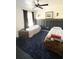 bedroom featuring twin beds, blue carpet, and a ceiling fan at 548 Big Sioux Ct, Kissimmee, FL 34759