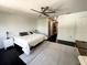 Bright bedroom featuring dark wood floors, a ceiling fan, a bed, and a walk through to another room at 548 Big Sioux Ct, Kissimmee, FL 34759