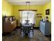 Cozy dining room featuring natural light from the windows and a vintage style cabinet at 548 Big Sioux Ct, Kissimmee, FL 34759
