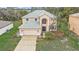 Two-story home featuring a large window, attached garage and a well maintained front yard at 548 Big Sioux Ct, Kissimmee, FL 34759