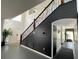 Bright foyer with staircase featuring decorative metal and wood banister and soaring ceilings at 548 Big Sioux Ct, Kissimmee, FL 34759