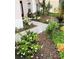Beautiful landscaping with colorful flowering shrubs and a concrete walkway to the front door at 548 Big Sioux Ct, Kissimmee, FL 34759